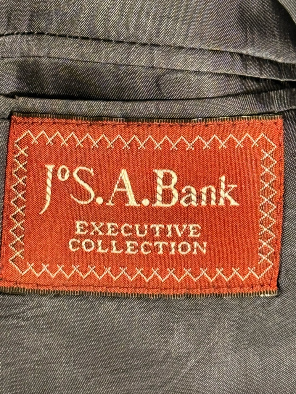 Jos. A. Bank Executive Collection Suit Label - Red Patch on Dark Gray Fabric
